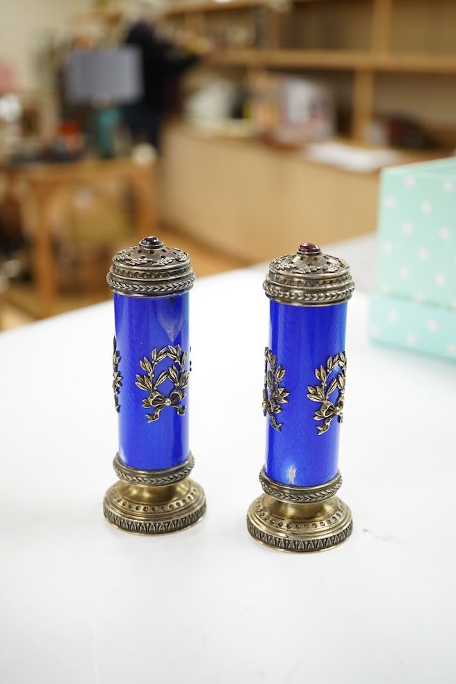 A cased pair of Russian style white metal and enamel cylindrical pedestal pepperettes, 10cm, enamel a.f. Condition - poor